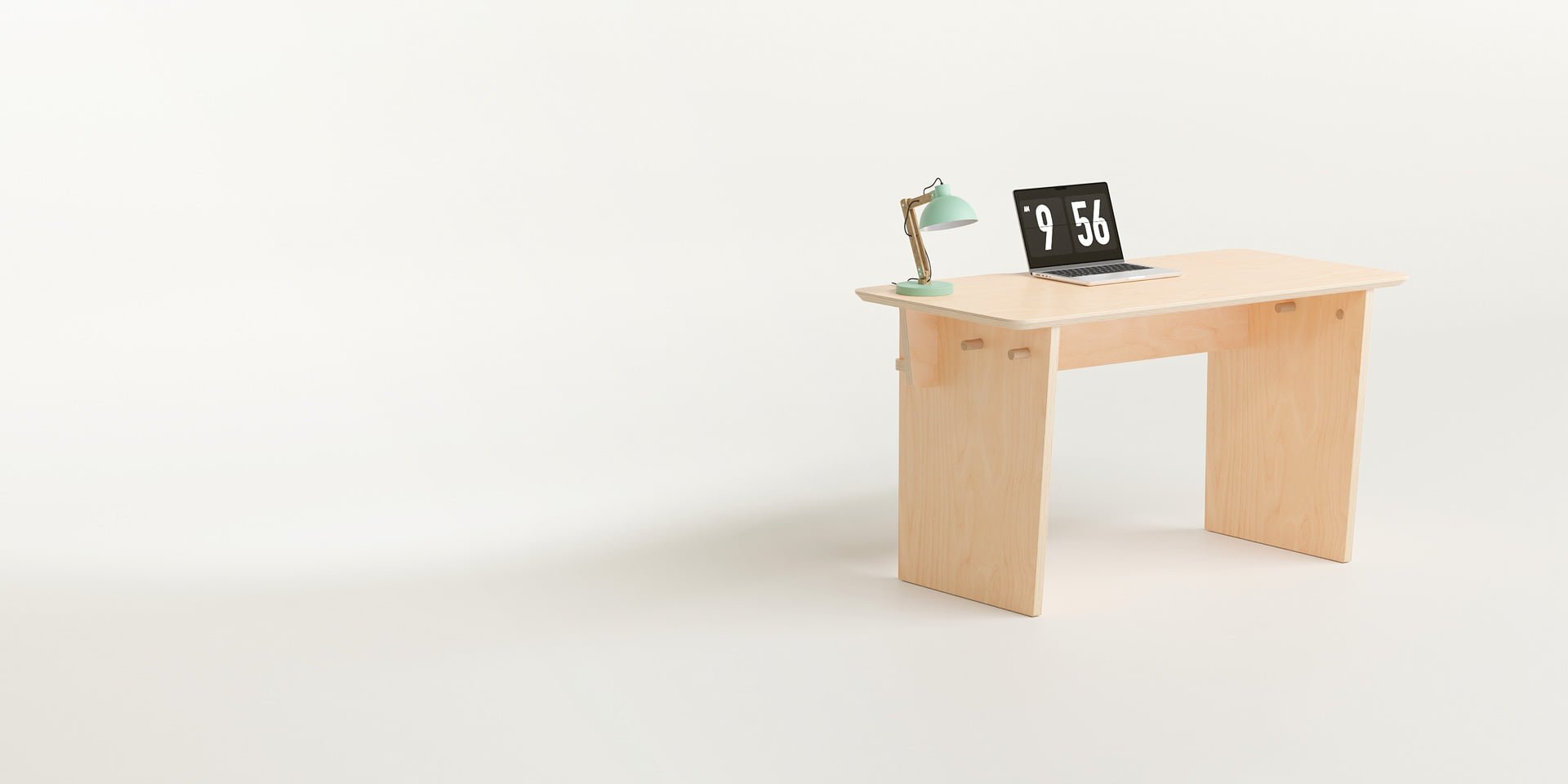 The Ecosium Stubby desk made from sustainable timber in Australia sitting on a white background with a green desk lamp and an Apple laptop