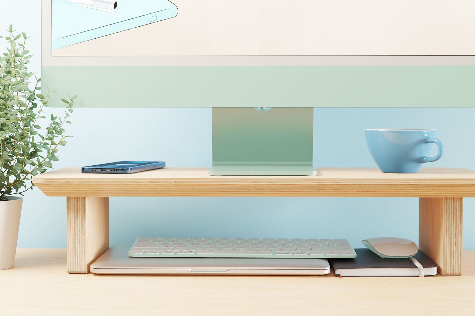 A front on view of the Ecosium medium size sustainable timber desk shelf against a blue wall with a green iMac on top, and a Macbook, keyboard and mouse stored underneath