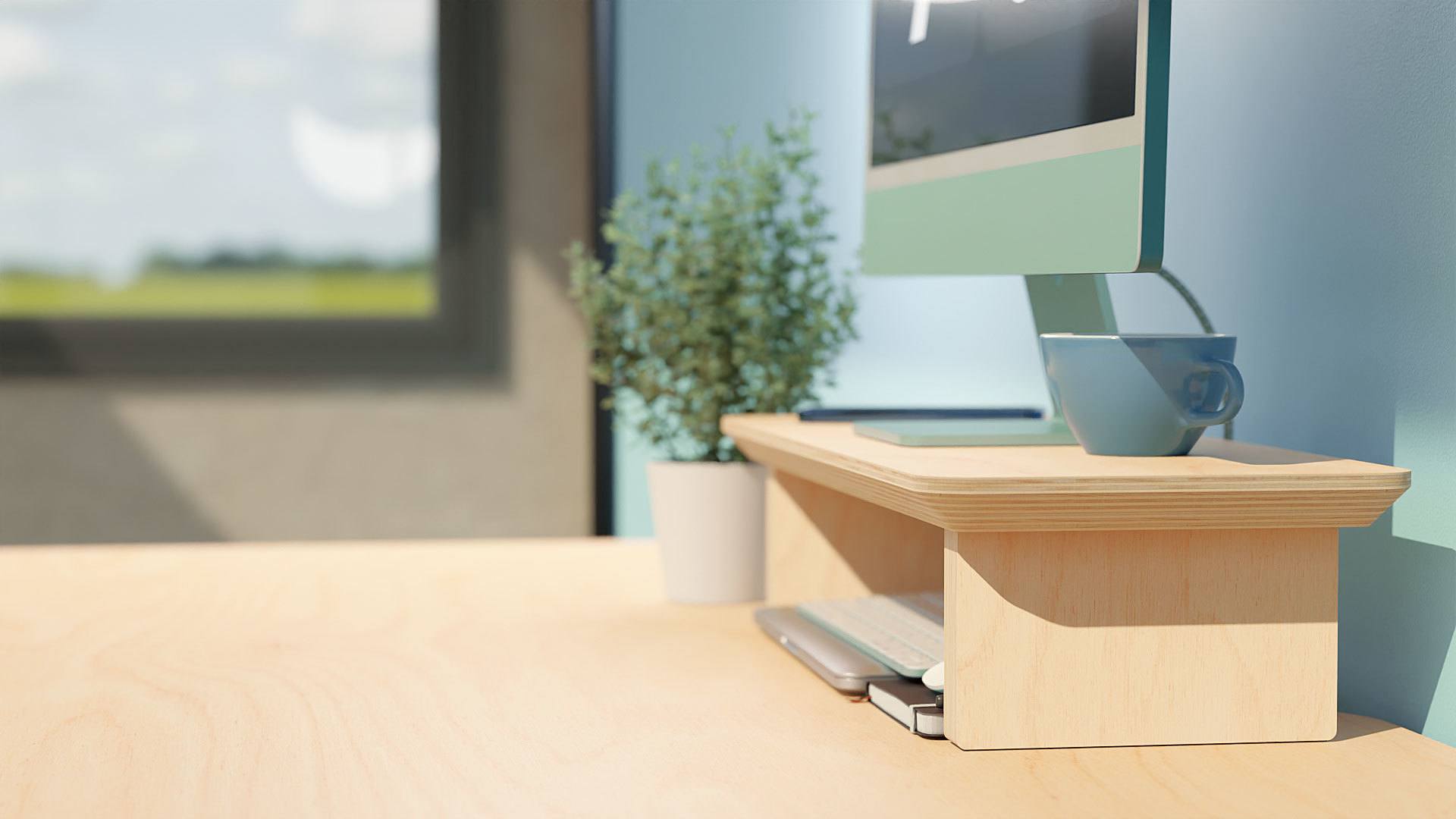 The Ecosium medium size sustainable timber desk shelf against a blue wall with a green iMac on top, and a Macbook, keyboard and mouse stored underneath